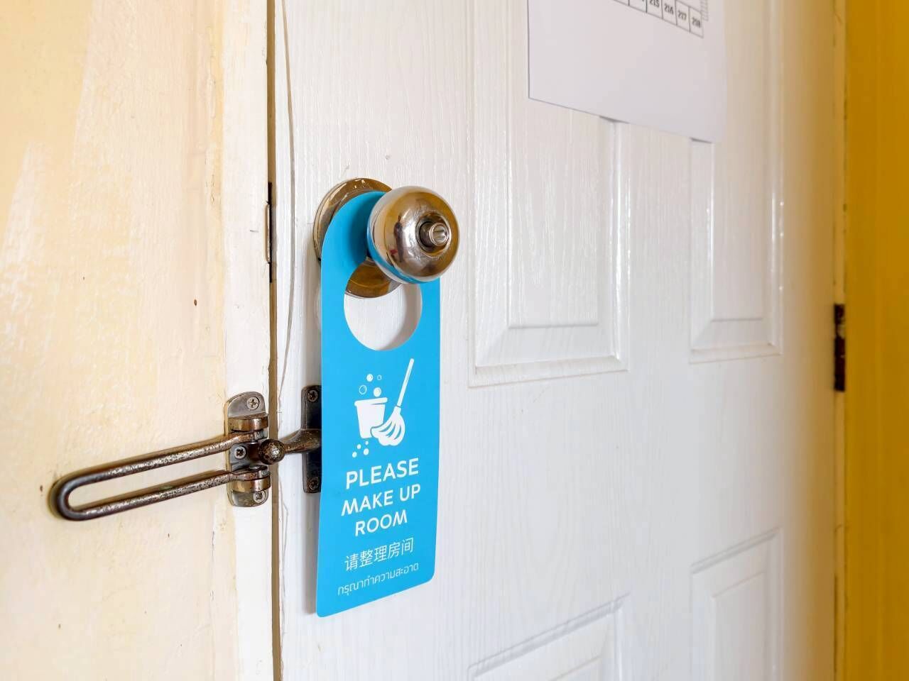 A door with a sign requesting to make up the room.
