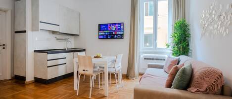 A modern apartment with a kitchen, dining area, and living room.