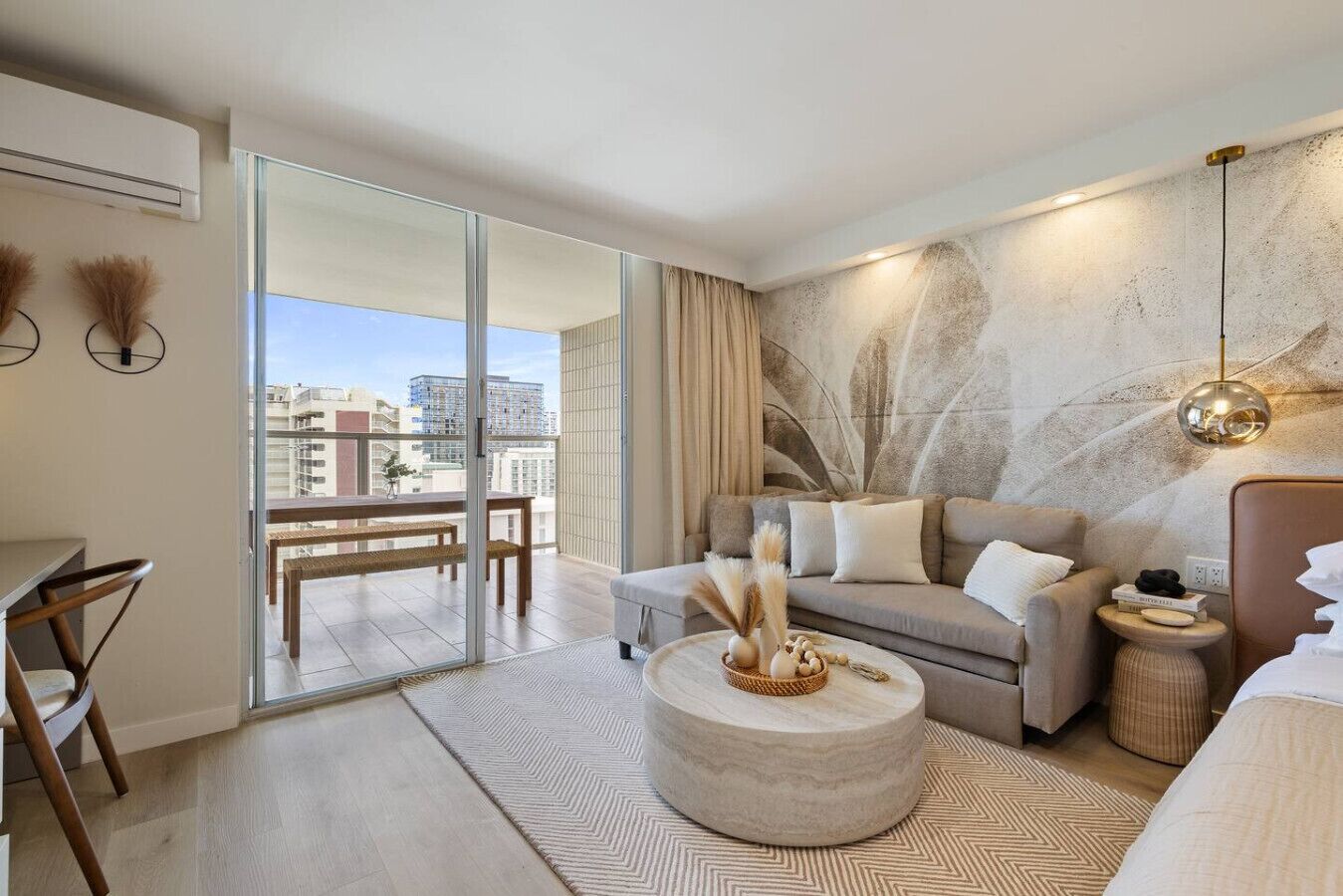 A modern living room with a sofa, coffee table, and a dining area with a table and chairs.