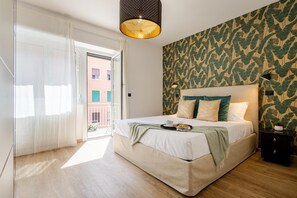 Een slaapkamer met een groot bed, uitzicht naar buiten en een behang met een patroon.