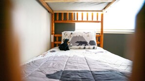 A single bed with a quilt, a pillow with a bear design, and a wooden headboard. - Hot Tub, Walk to Town, Lake Access, Fireplace, Fenced Yard (Twain Harte)