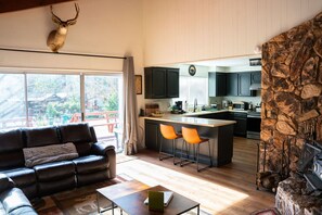 A modern living room with a leather sofa, a coffee table, and a fireplace.
