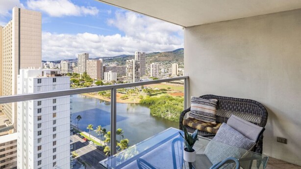 A balcony with a view of a cityscape and a river. - Heart of Waikiki • Steps to Beach • Cozy Studio (Honolulu)