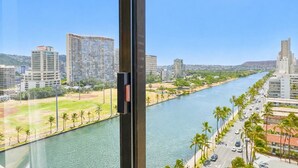 A river with a cityscape, including high-rise buildings and a clear sky. - Waikiki Skyline Corner Ocean View Studio (Honolulu)