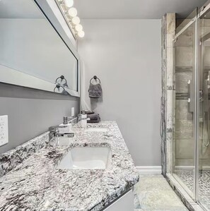 Shower, hair dryer, towels, toilet paper