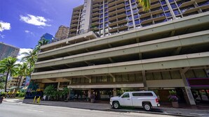 A multi-story parking garage with a building adjacent to it. - PW9F-23 Modern Cozy Waikiki Studio Across Hilton Village 9 (Honolulu)