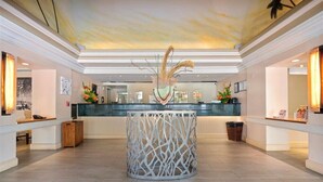 A lobby with a central reception desk, a decorative white column, and a ceiling with a painted mural. - PW9F-23 Modern Cozy Waikiki Studio Across Hilton Village 9 (Honolulu)