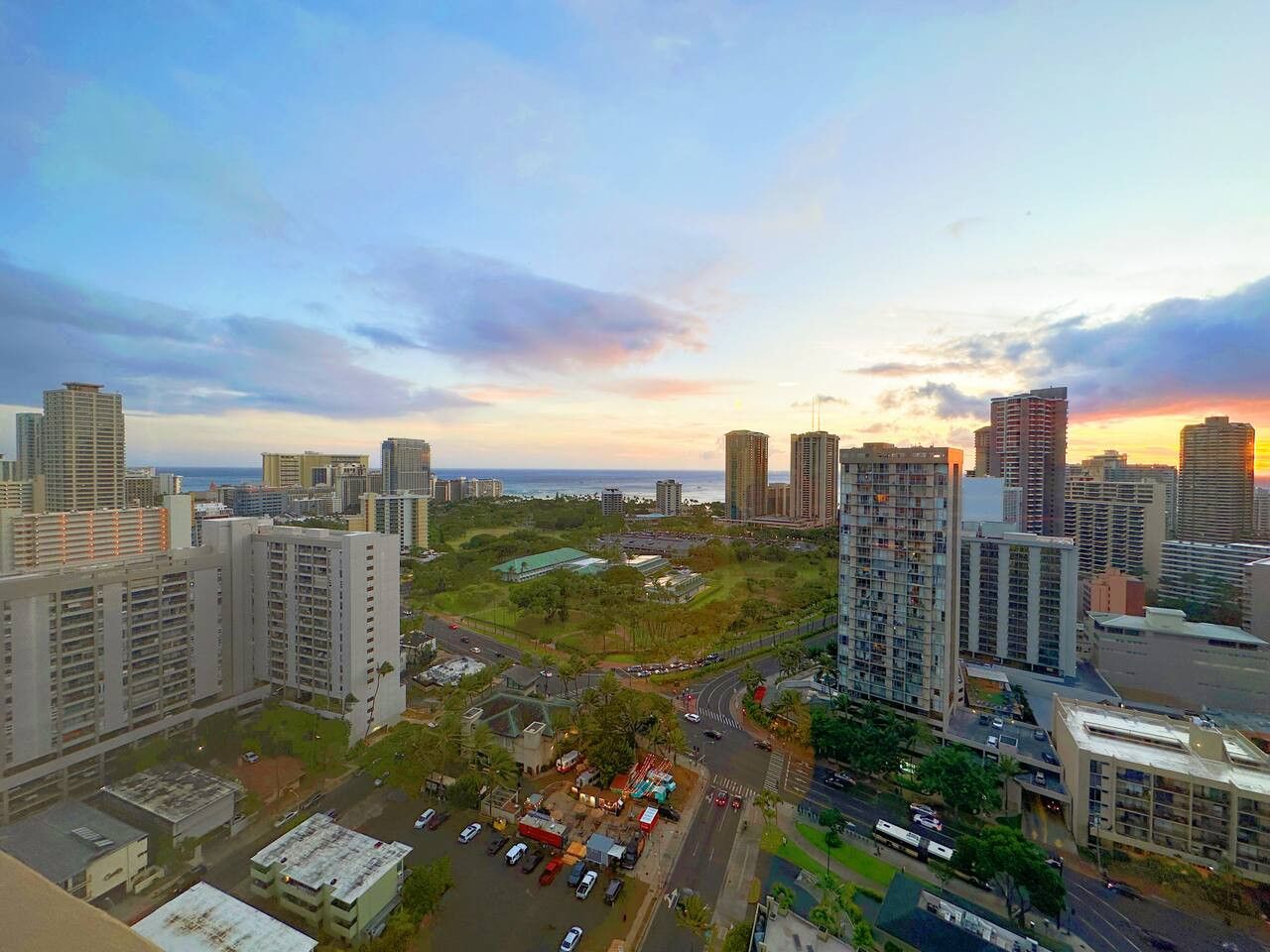 A cityscape with high-rise buildings, a central park, and a road network.