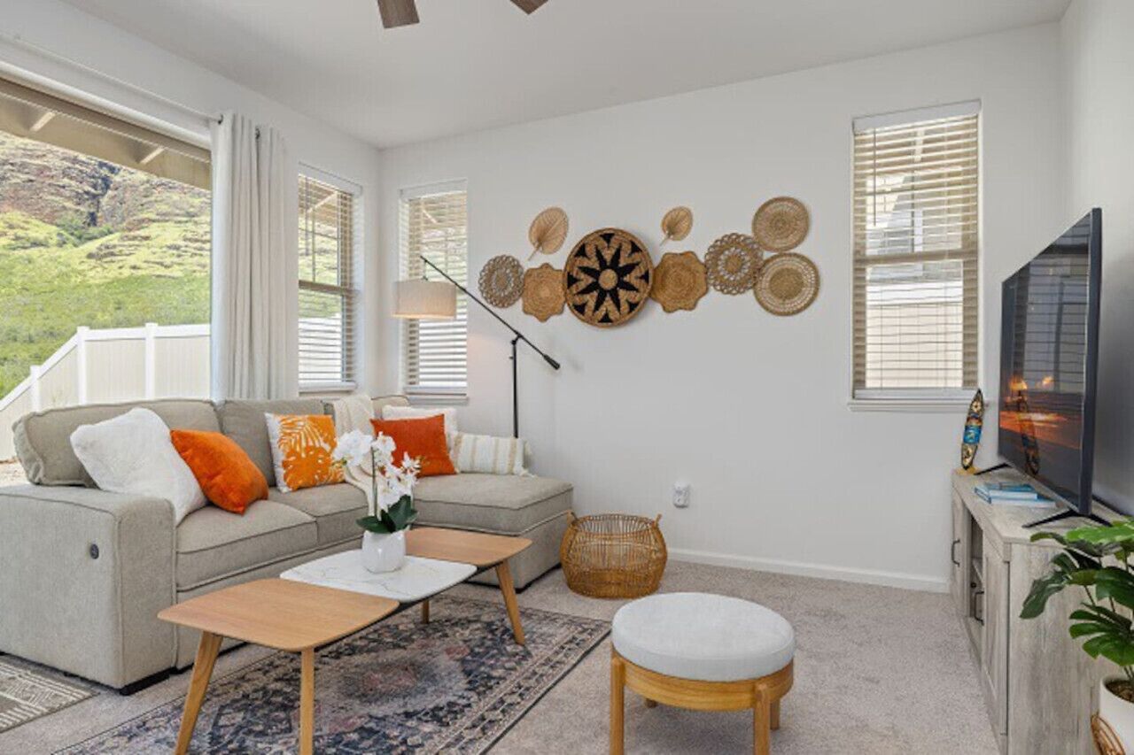 A living room with a sofa, coffee table, and TV stand.