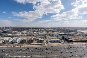 A cityscape with a highway and buildings. - Samaya Holiday Homes Cloud Suites (Dubai)