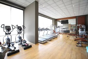 A gym with treadmills, elliptical machines, and weight equipment. - Elegant 2BR Luxury Apt•Modern, Cozy, Airport Pool, Mirage , Accra  (Accra)