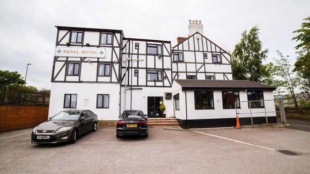 A two-story building with a sign reading "ROYAL HOTEL". There are two cars parked in front. - Standard Twin Room (Gateshead)