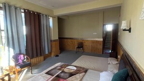 A hotel room with a large bed, a desk, and a chair. There is a staircase leading to an upper level. - Tanghaa Resort By Mountain Bee (Nako)