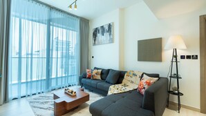 A modern living room with a grey sofa, a wooden coffee table, and a floor lamp.