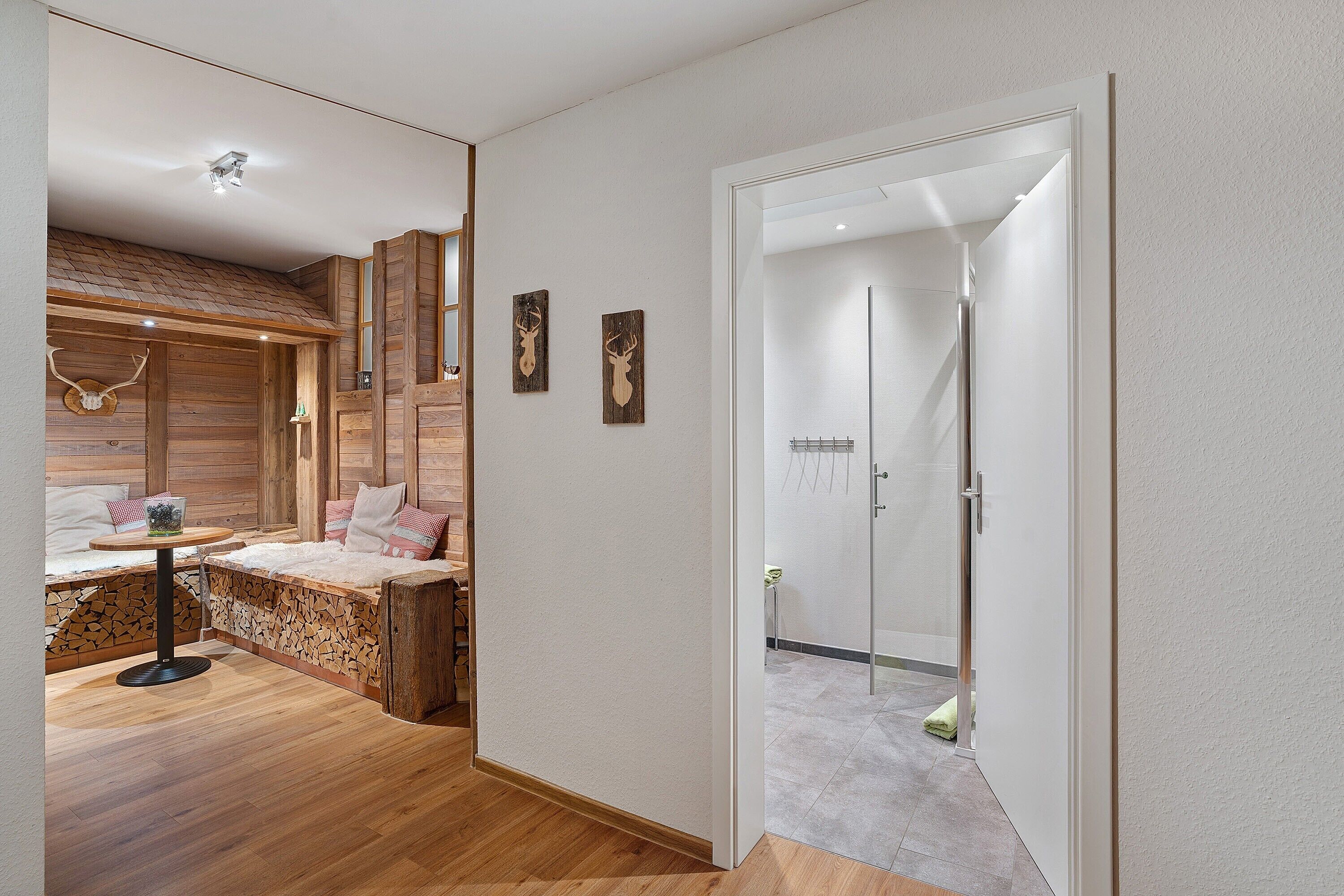 A modern bedroom with a wooden headboard, a bedside table, and a nightstand.