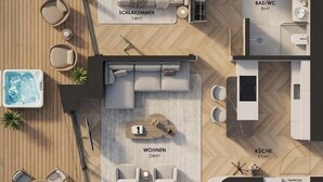 A hotel layout with a bedroom, bathroom, living area, and kitchenette.