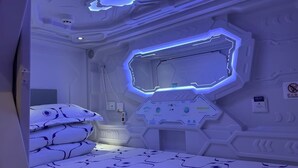 A futuristic room with a bed, control panels, and a no-smoking sign. - Take a nap hotel (Xianyang)
