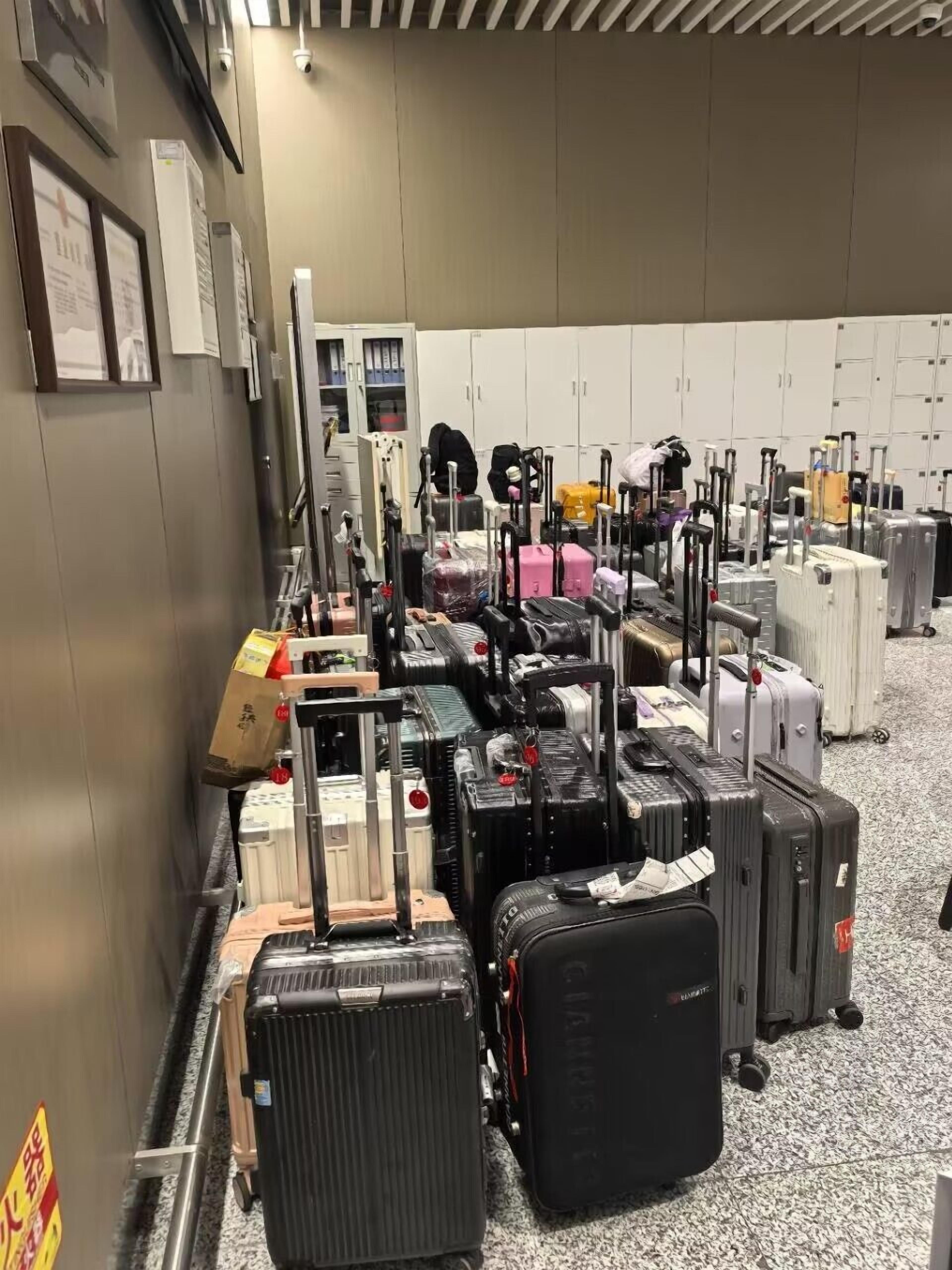 A luggage carousel with various suitcases and bags.