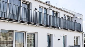 A modern two-story building with balconies, large windows, and a clean facade. - Munich Finest Apartments Studio 11 by Interhome (Munich)