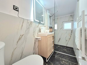A modern bathroom with a marble wall, a wooden vanity, a glass shower enclosure, and a white toilet. - Central Inn Brasov (Brașov)