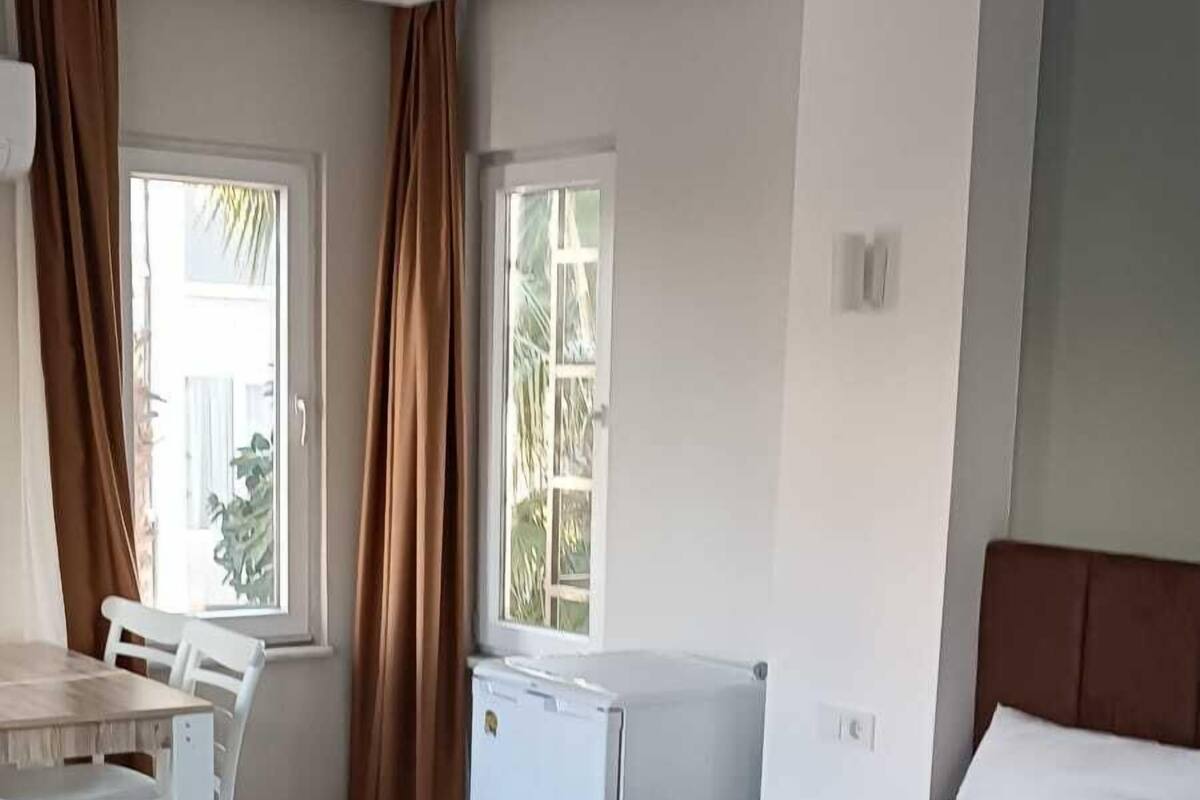 A hotel room with a bed, a desk, and a chair.