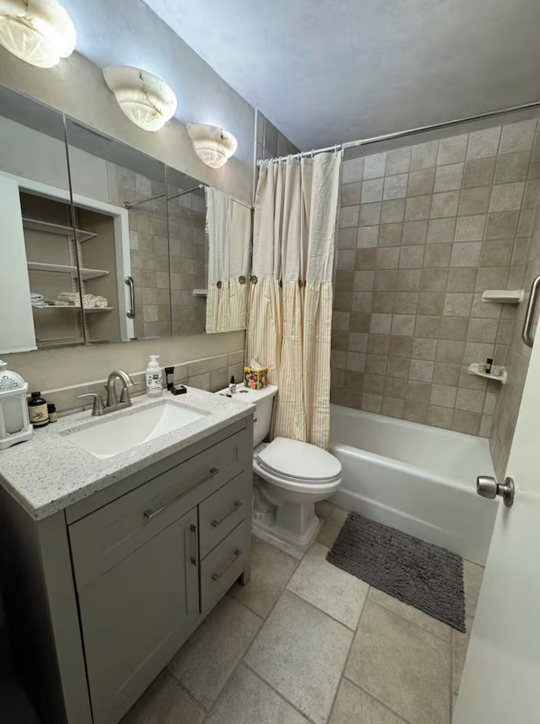 A bathroom with two sinks, a toilet, a bathtub, and a shower curtain.