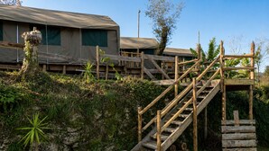 A wooden staircase leading to a building with a covered entrance.