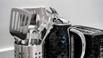 A kitchen utensil holder with various utensils, including a spatula and a ladle.