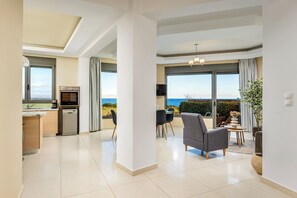A modern interior with a kitchen, dining area, and a view of the sea. - Aqua Natura Villas - Villa Delfinus (Rhodes)