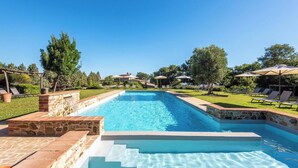 A rectangular swimming pool with a stone border and steps leading into the water. - Villa Aquila-cignella Resort Acommodation Tuscany (Trequanda)