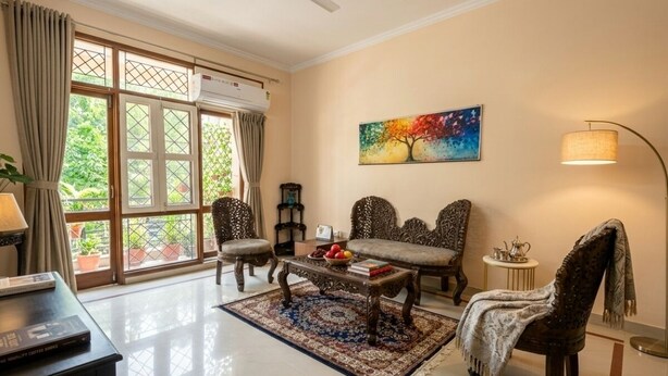A living room with a sofa, armchairs, a coffee table, and a painting on the wall. - Taj Luxuria by Red Olive10min to Taj Mahal3bhk (Agra)