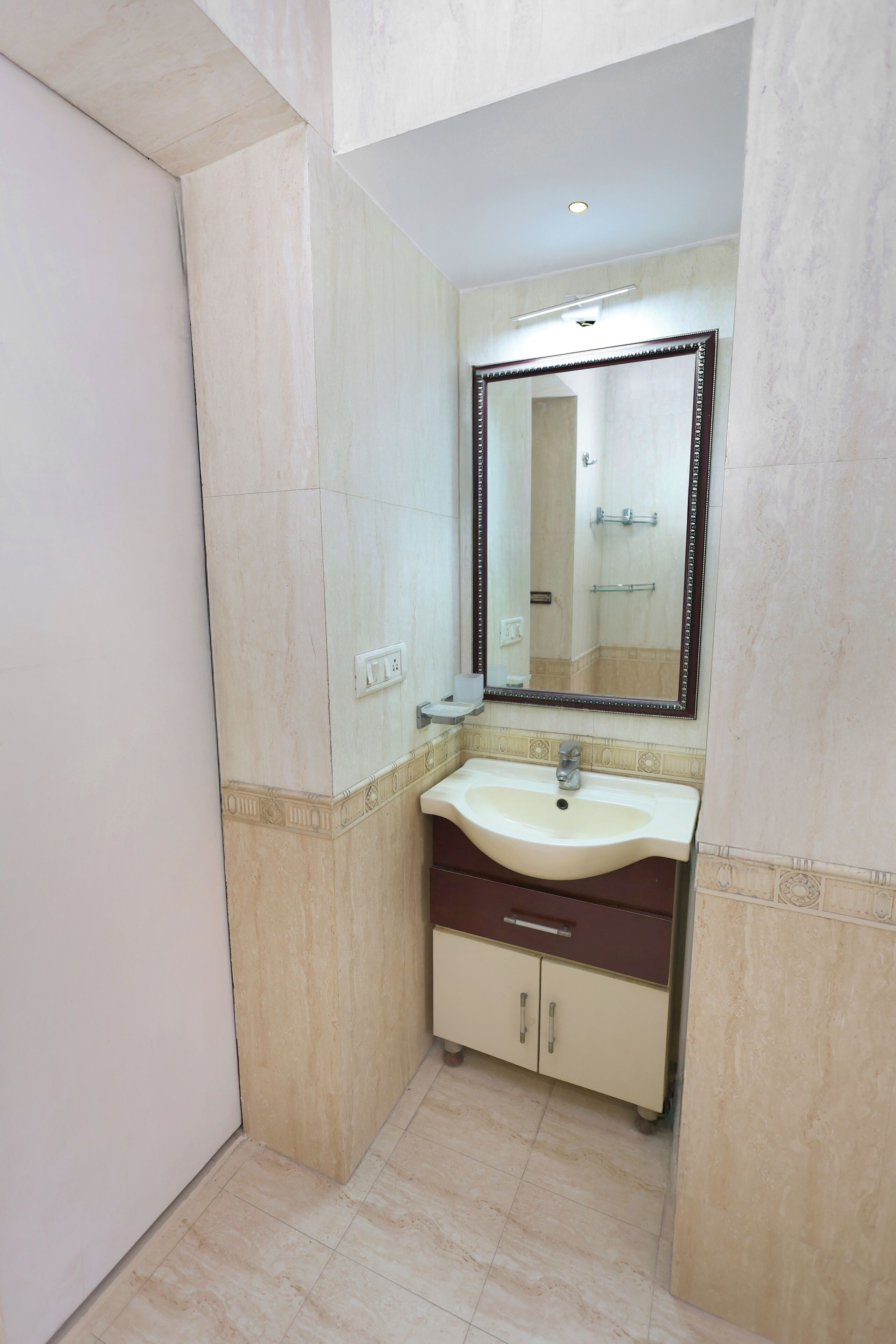 A bathroom with a sink, mirror, and cabinets.