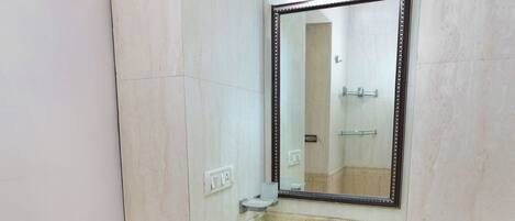 A bathroom with a sink, mirror, and cabinets.