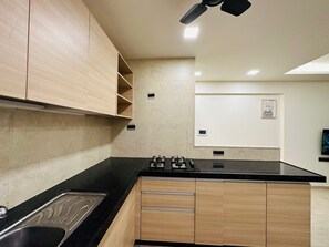 Refrigerador, placa de cocina, utensilios de cocina, mesa de comedor