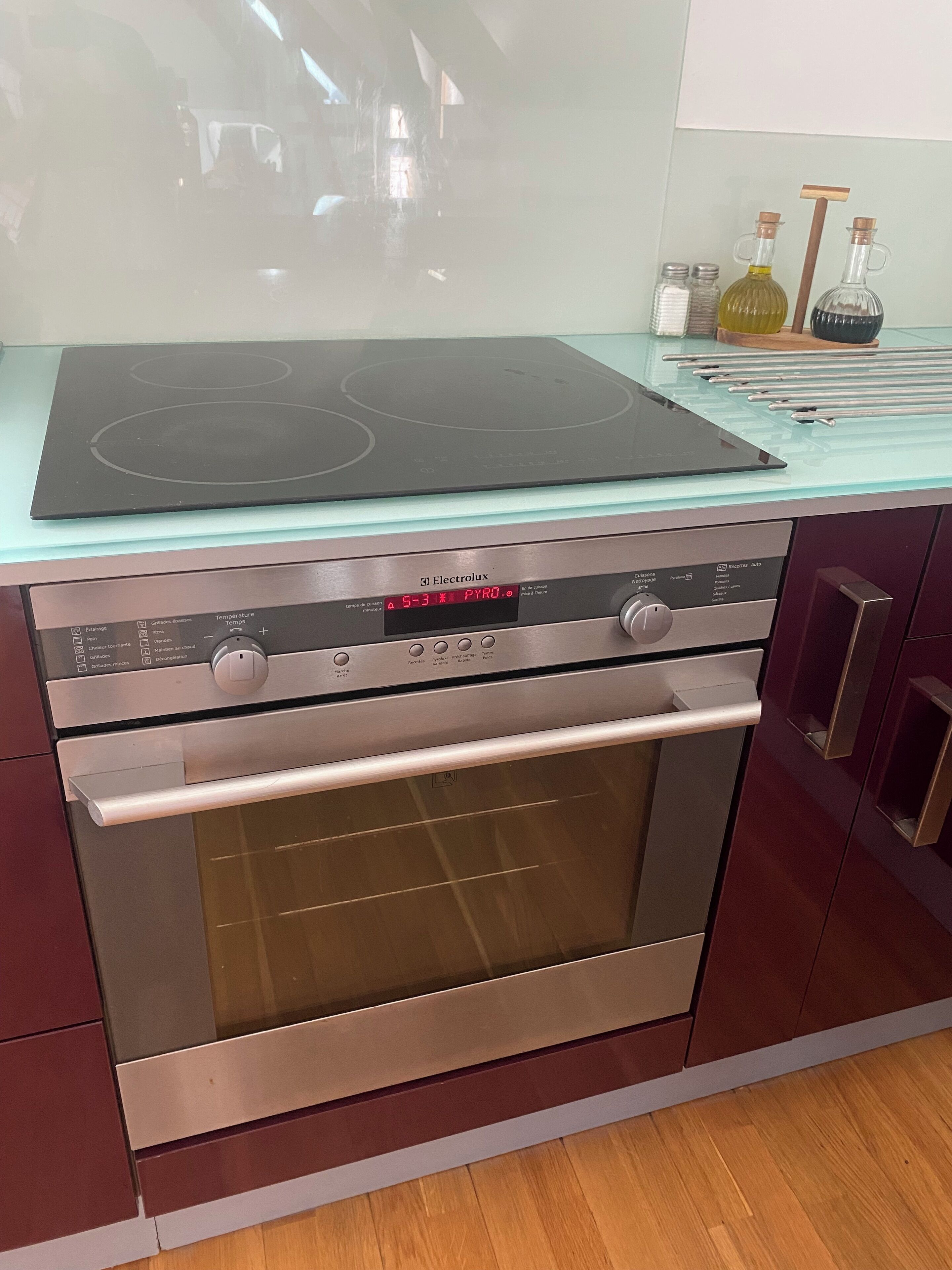 A kitchen with a built-in oven and a stovetop.