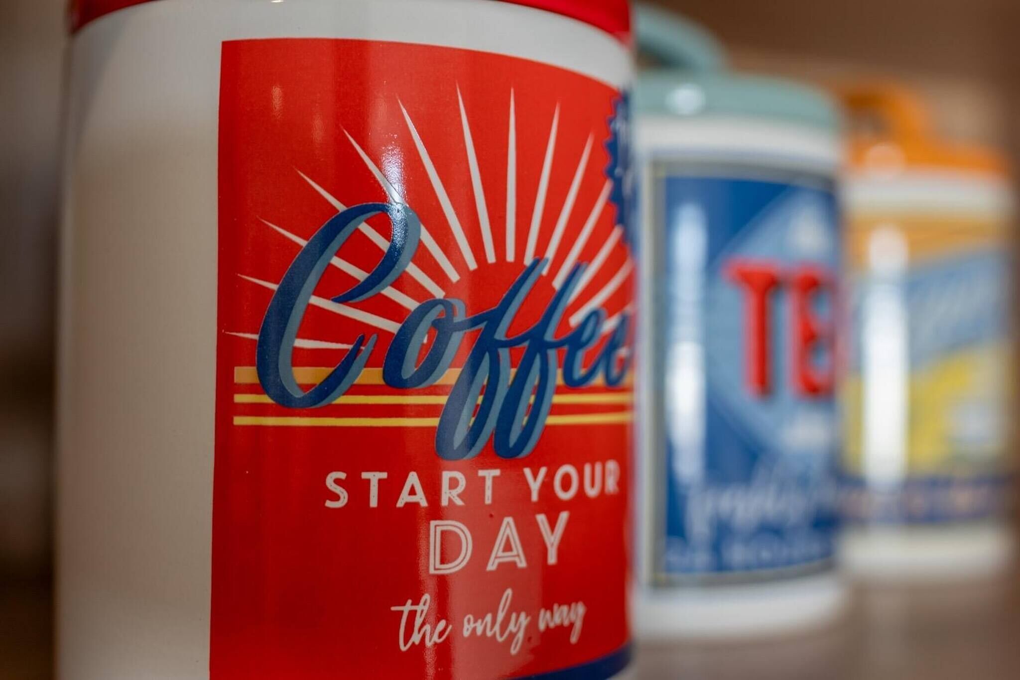 A close-up of a coffee container with the text "Coffee Start Your Day the only way".