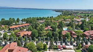 Una zona residencial con casas, una piscina y vistas al mar.