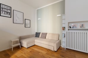 Living area - GuestHost - Cozy 47 sqm apartment for up to 3 guests, located on the first floor of a building without an elevator (steps to access).The property is set in the Isola district, a young and vibrant area rich in services and well connected by public transpo (Milan)