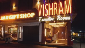 A building with a sign for 'Vishram Executive Rooms' and a 'Jargift Shop' below it. - Vishram Executive Rooms (Vasai)