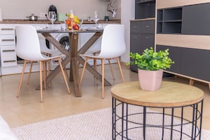 A modern kitchen with a dining table, chairs, and a potted plant. - Modern, centrally located, with private parking and an elevator   (Altea)