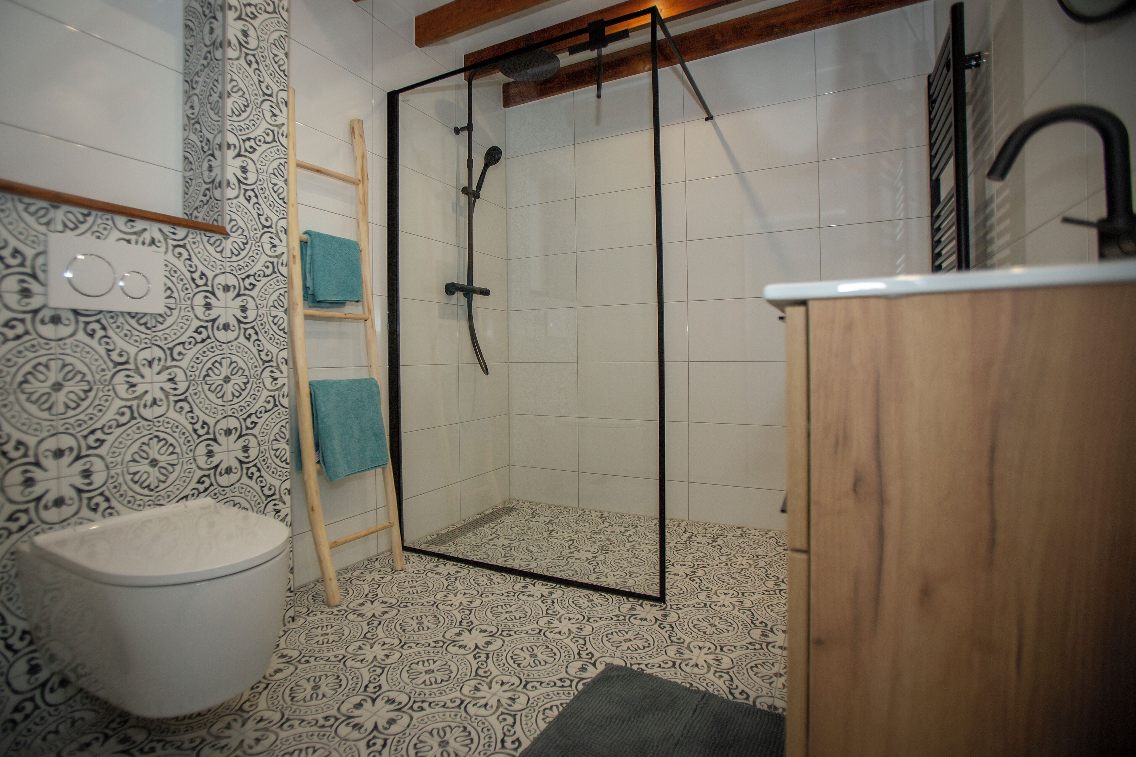 A bathroom with a shower, toilet, and sink.