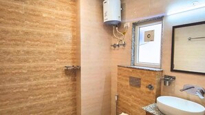 A bathroom with a shower, toilet, and sink. - Kommune Living (Gurugram)