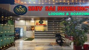 The exterior of Shiv Sai Residency, featuring a prominent signage, a staircase leading to the entrance, and a parked scooter. - Shiv Sai Residency Lodging & Boarding (Vasai)