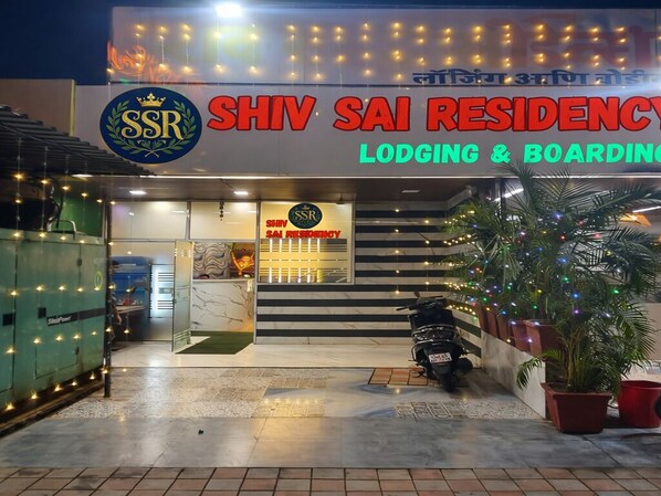 The exterior of Shiv Sai Residency, featuring a prominent signage, a staircase leading to the entrance, and a parked scooter. - Shiv Sai Residency Lodging & Boarding (Vasai)