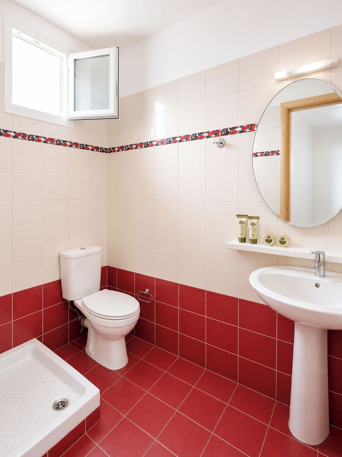 A bathroom with a toilet, sink, and shower.