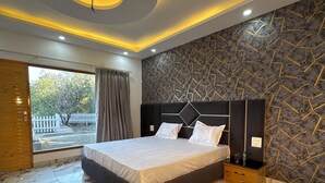 A modern bedroom with a marble floor, a large bed, and a unique ceiling design. - SECRET ESCAPE RESORT (Solan)
