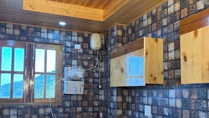 A kitchen with wooden cabinets, a tiled backsplash, and a window. - SECRET ESCAPE RESORT (Solan)