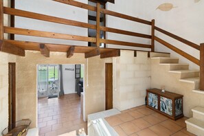 A staircase with wooden railings, a tiled floor, and a cabinet with a decorative panel. - Holiday Home Les Naudines with Shared Pools – Near Bergerac (gageac et rouillac)