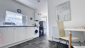 Full-sized fridge, microwave, oven, cookware/dishes/utensils