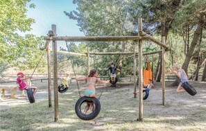 A playground with swings and tire swings. - The Charming Marina Village Tipo3-3 Bedroom Villa 6 Persons (Comacchio)